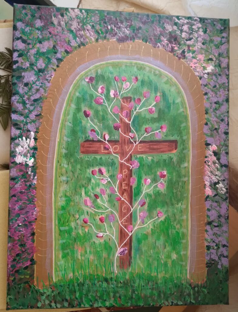 Croix entourée de fleurs violettes avec "love" et "peace" écrits