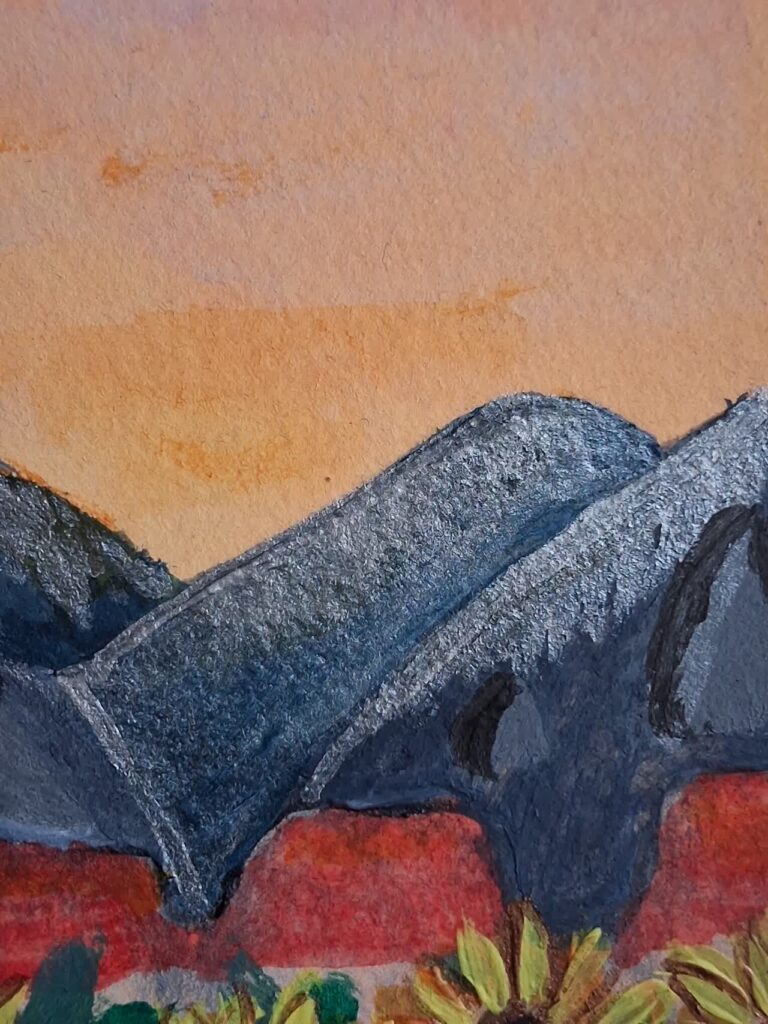 Ciel orange du tableau "les tournesols", au dessus des montagnes